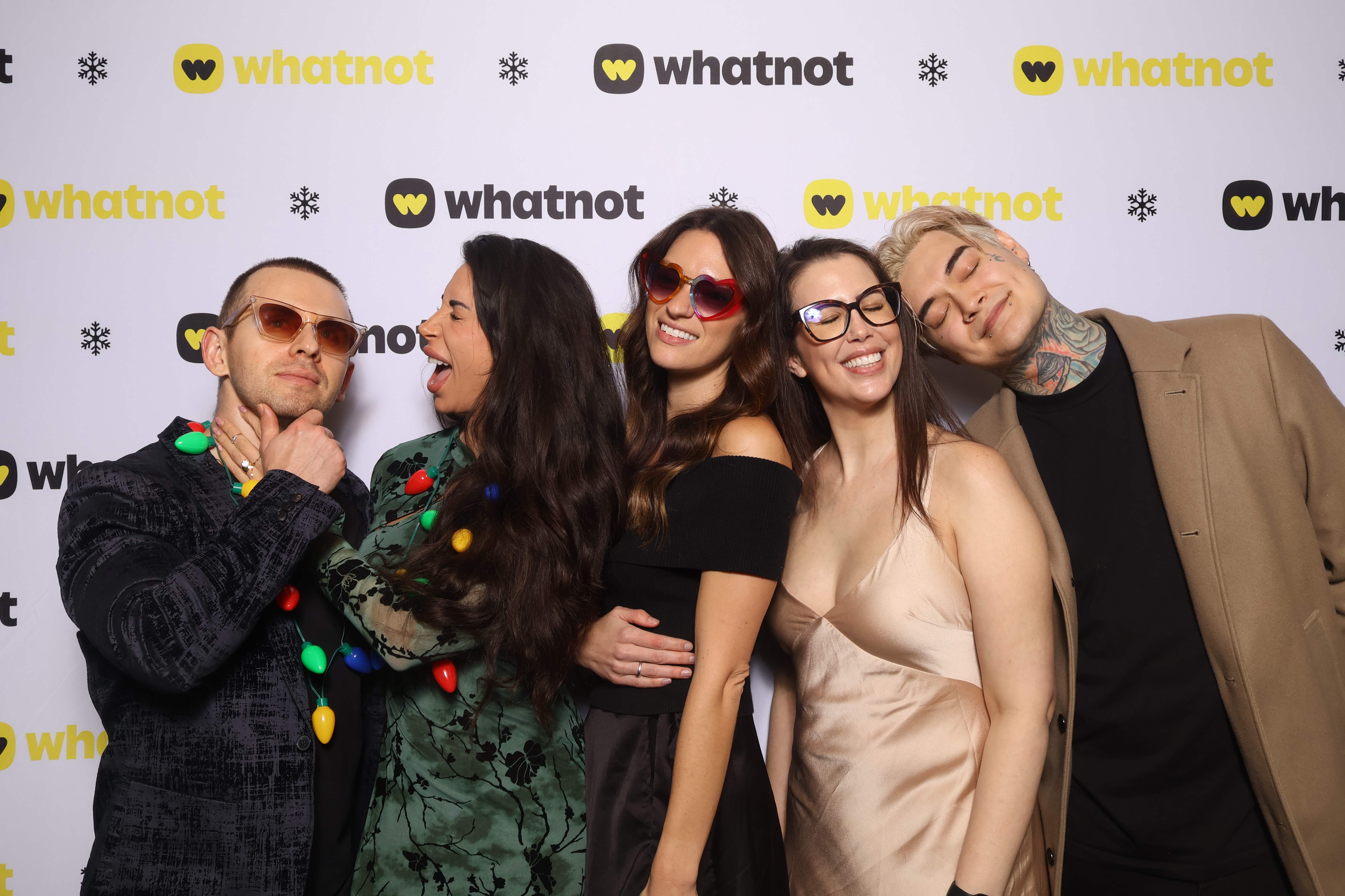 Guests posing in front of a branded custom Whatnot backdrop.