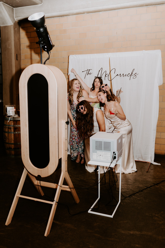 Elegant wedding photobooth setup with rustic charm